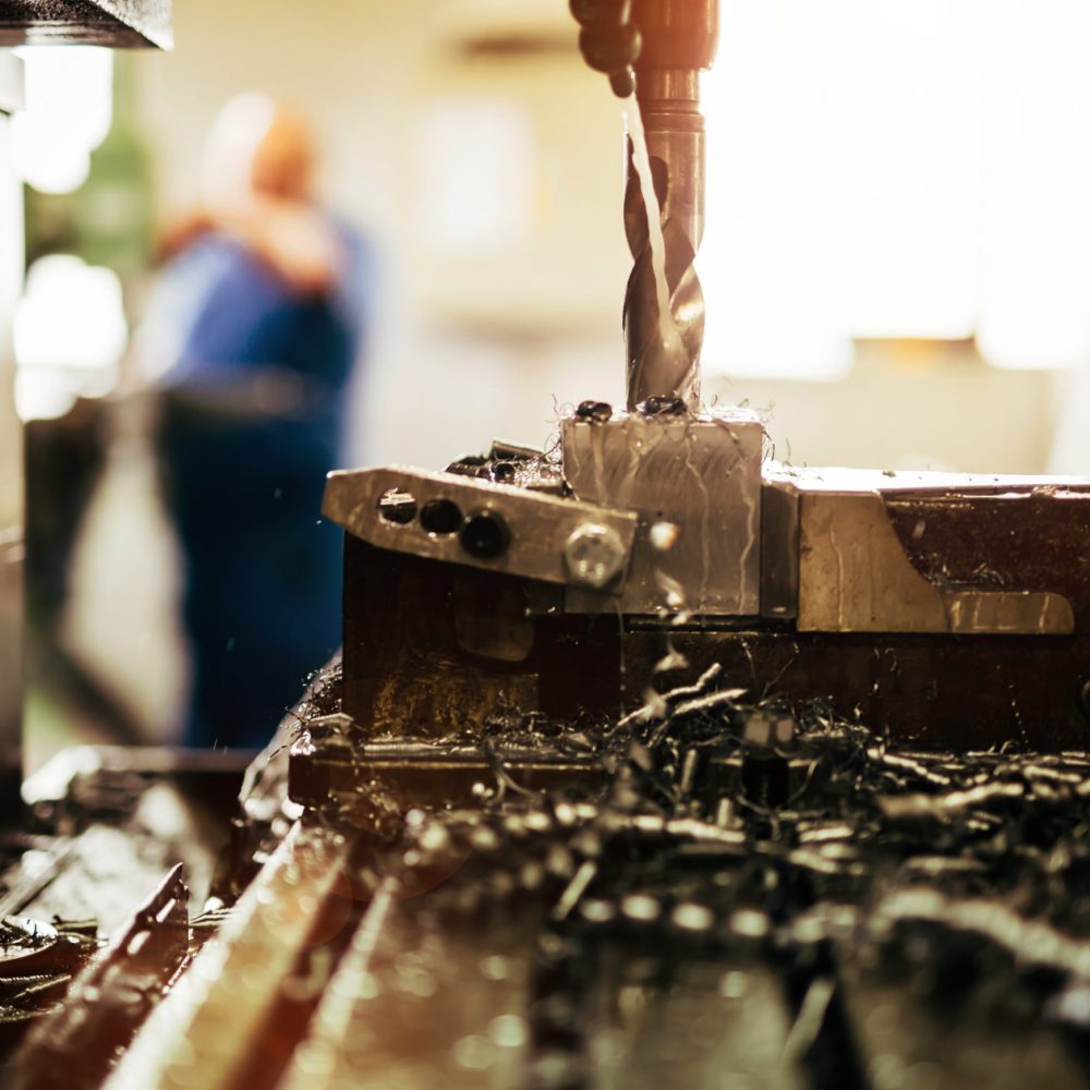 Automated drilling machines processing metalwork for assembly robots